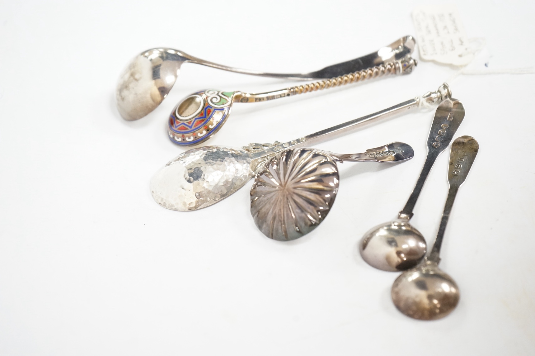 A George VI Arts & Crafts silver seal top spoon by Amy Sandheim, London, 1948, 14.2cm, a 19th century Russian 88 zolotnik and enamel spoon, assay master B.C, 1874, a 19th century silver caddy spoon and three silver ladle